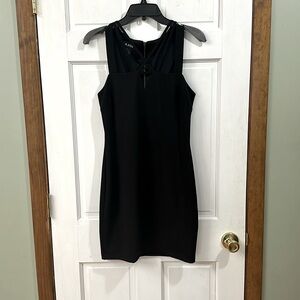 Black dress with copper colored back zipper. Cross cross in the chest area